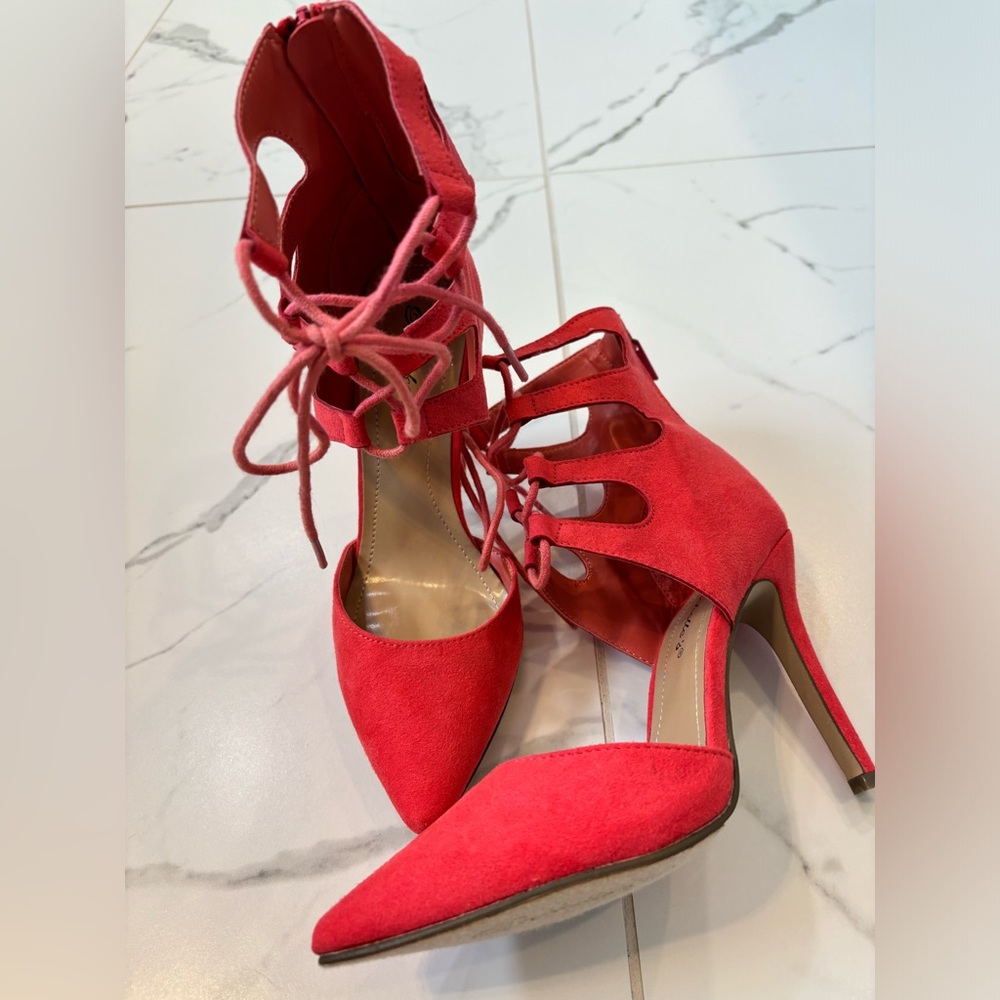 Breckelle’s (6) bright coral lace up heels.